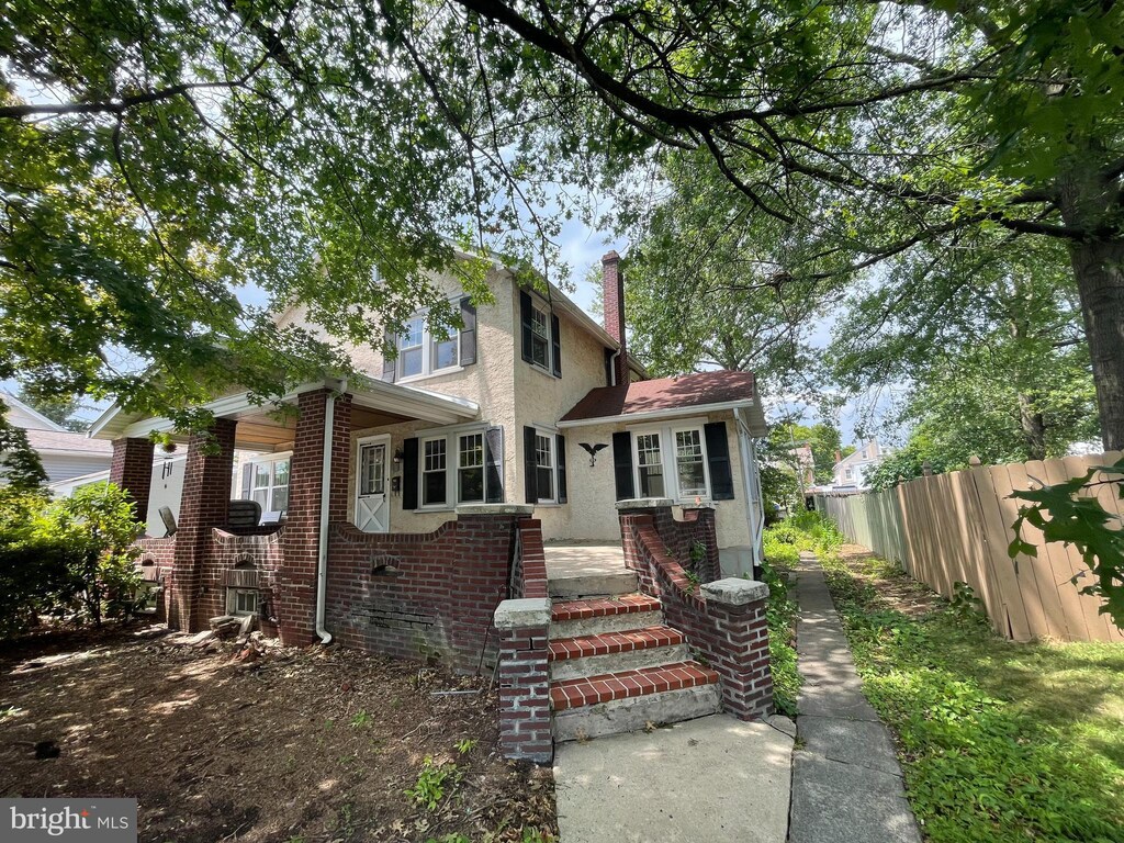 783 N Evans St, Pottstown, PA 19464 - traditional home with fence, a chimney, stucco siding, and brick siding