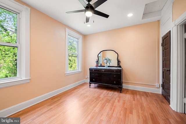 bedroom with baseboards, a ceiling fan, and light wood-style flooring