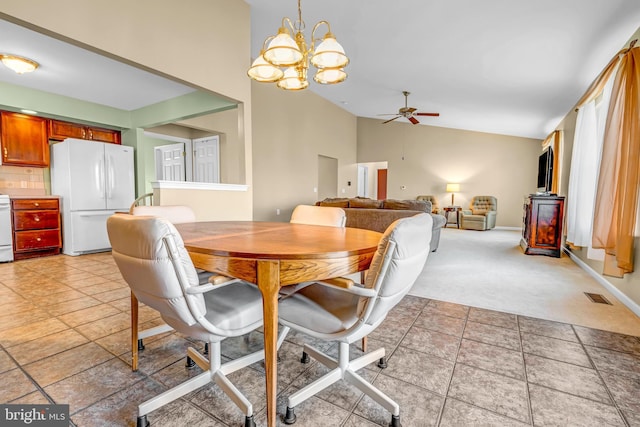 4741 Dunham Dr, Reading, PA 19606 - dining room featuring light colored carpet, high vaulted ceiling, ceiling fan with notable chandelier, baseboards, and visible vents