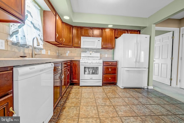 4741 Dunham Dr, Reading, PA 19606 - kitchen featuring decorative backsplash, white appliances, light countertops, a sink, and stone finish flooring