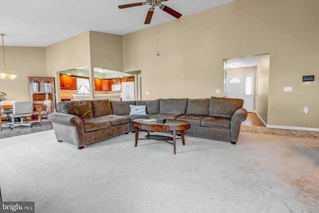 4741 Dunham Dr, Reading, PA 19606 - living area featuring light colored carpet, baseboards, ceiling fan with notable chandelier, and high vaulted ceiling
