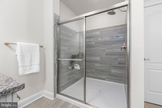 full bath featuring baseboards and a stall shower