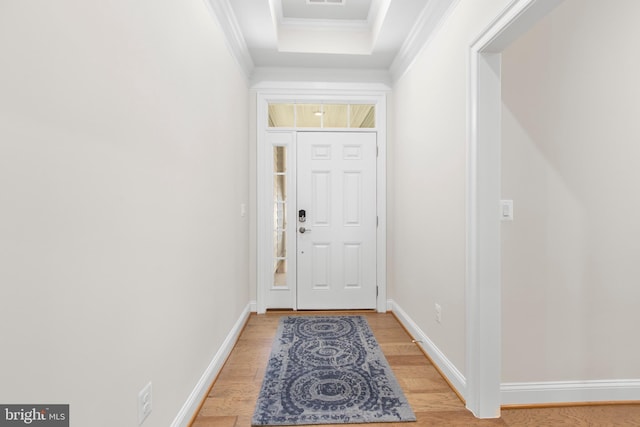 doorway to outside with light wood-type flooring, baseboards, and crown molding