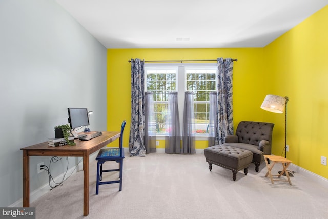carpeted office space featuring baseboards and visible vents