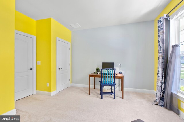 carpeted office space with baseboards and plenty of natural light