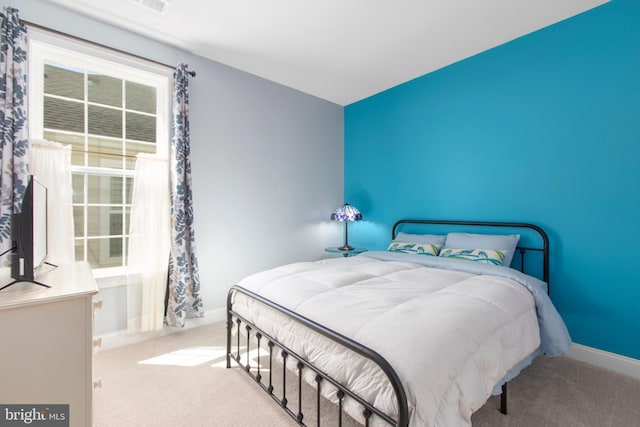 bedroom with carpet floors and baseboards