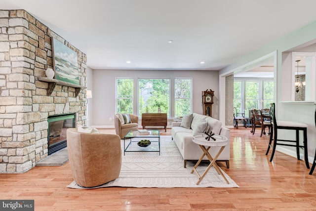 living area featuring wood finished floors, a fireplace, and baseboards