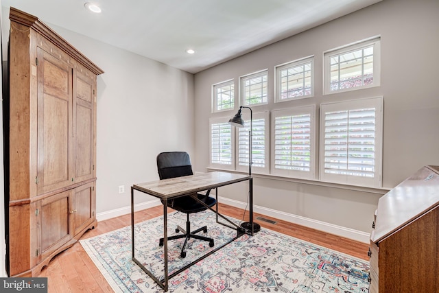 home office featuring light wood-type flooring, baseboards, and recessed lighting