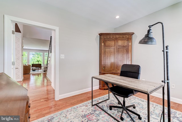 office area featuring light wood-type flooring, baseboards, lofted ceiling, and recessed lighting