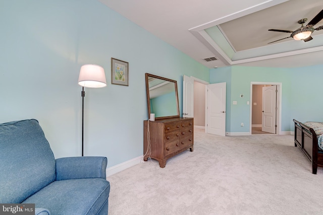 sitting room with light colored carpet, a ceiling fan, and baseboards