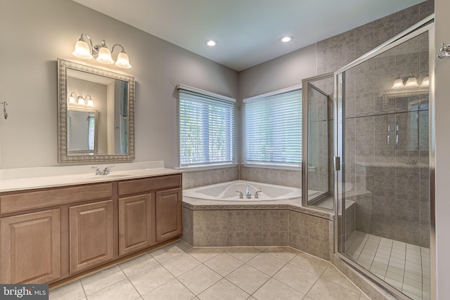 bathroom with tile patterned floors, a garden tub, a stall shower, vanity, and recessed lighting