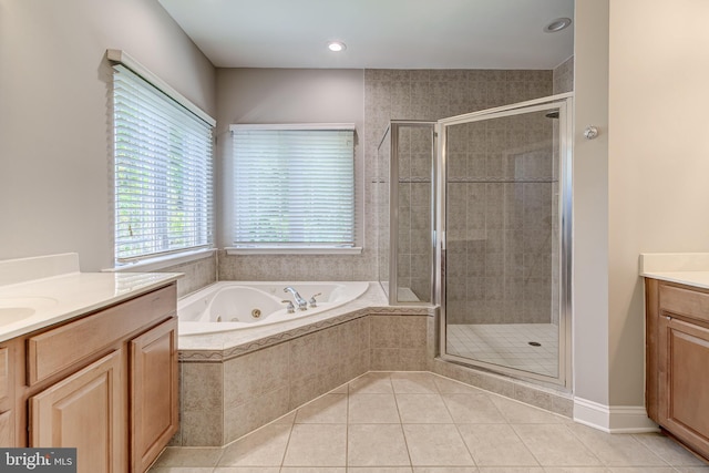 bathroom featuring vanity, a shower stall, tile patterned floors, and a jetted tub