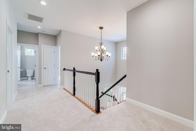 hall featuring an upstairs landing, carpet, a chandelier, plenty of natural light, and recessed lighting