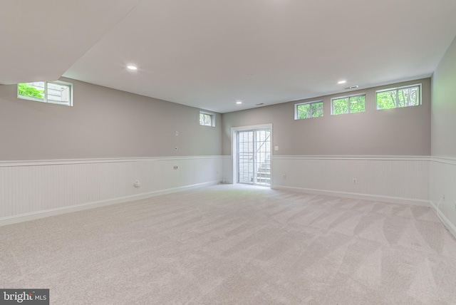 basement with wainscoting, carpet floors, and recessed lighting