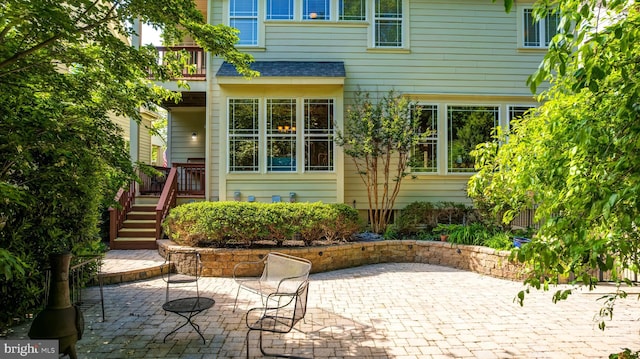 back of house with a patio area and a balcony