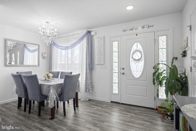 foyer with recessed lighting, baseboards, an inviting chandelier, and wood finished floors