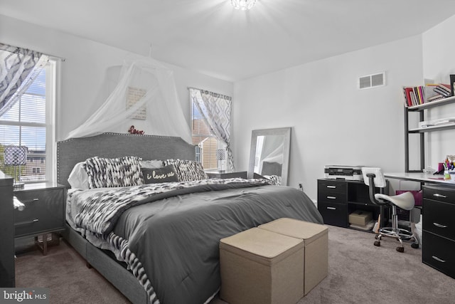 bedroom with multiple windows, carpet flooring, and visible vents