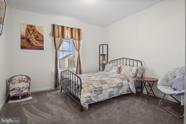 carpeted bedroom featuring baseboards