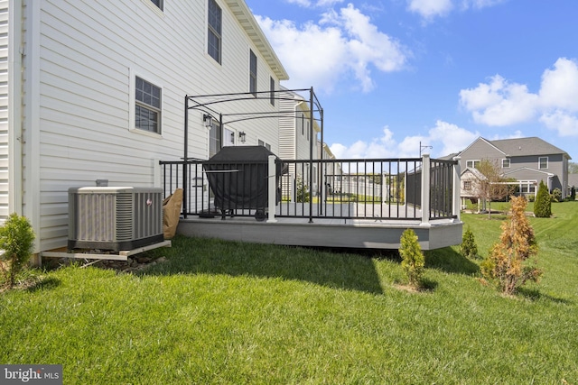 exterior space featuring a lawn and central AC