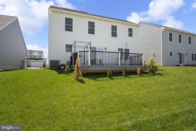 back of property featuring central air condition unit, a deck, and a yard