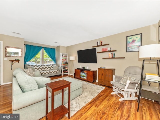 living room with wood finished floors and visible vents