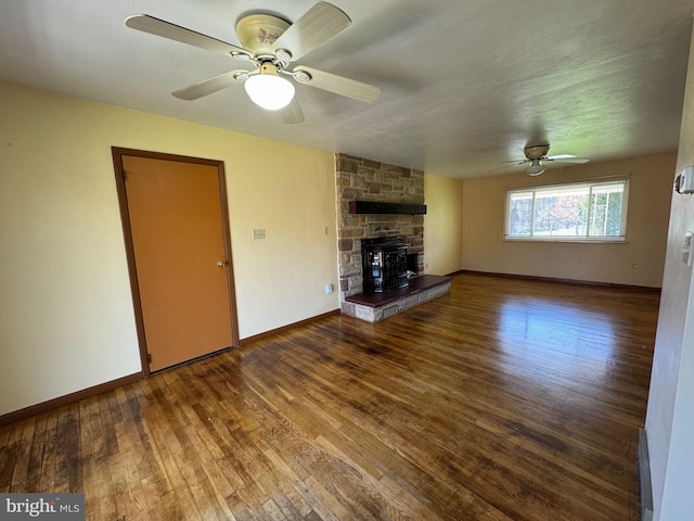 unfurnished living room featuring baseboards, wood finished floors, and a ceiling fan