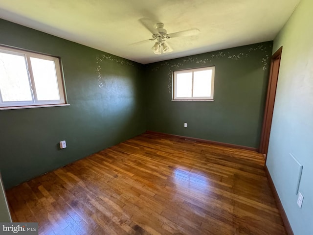 spare room with a ceiling fan and wood finished floors