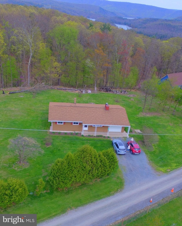 bird's eye view with a wooded view