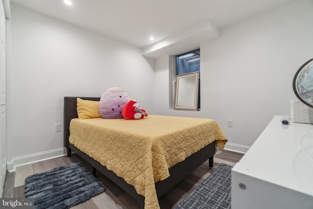 bedroom featuring baseboards, recessed lighting, and wood finished floors