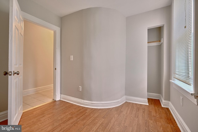 unfurnished bedroom featuring baseboards and light wood-style floors