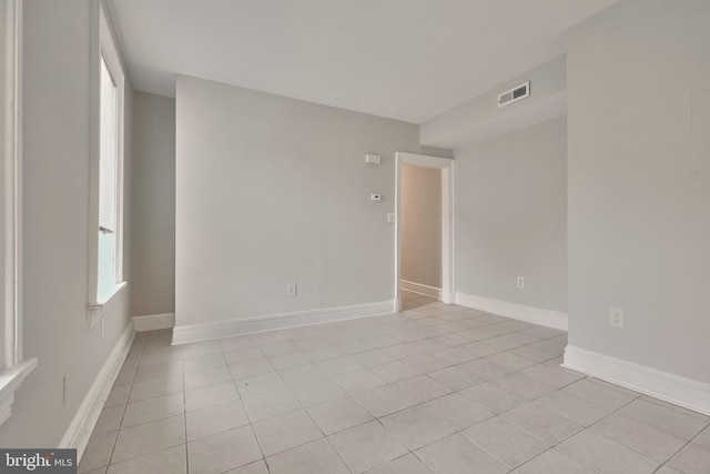 spare room with visible vents, baseboards, and light tile patterned flooring