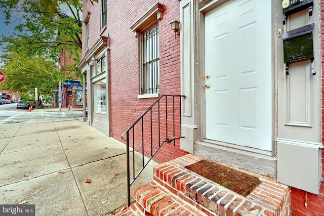 entrance to property with brick siding
