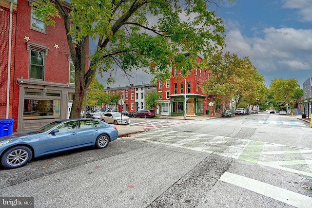 view of road with street lights, sidewalks, and curbs