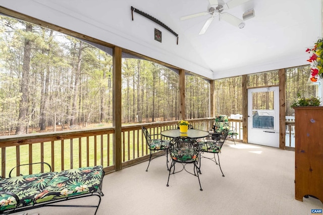 sunroom / solarium featuring outdoor dining area, a ceiling fan, and plenty of natural light