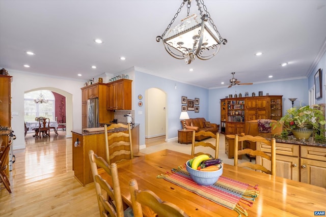 dining space with recessed lighting, arched walkways, and ceiling fan with notable chandelier
