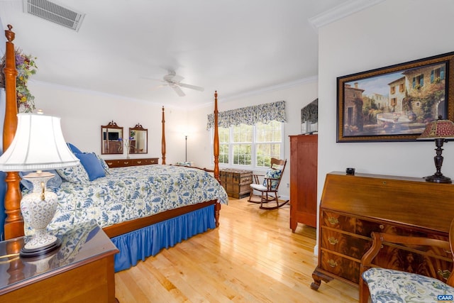 bedroom with visible vents, crown molding, hardwood / wood-style floors, and ceiling fan
