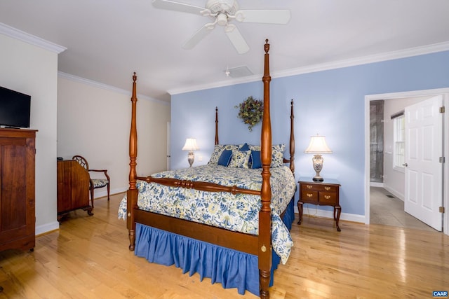 bedroom featuring crown molding, baseboards, and wood finished floors