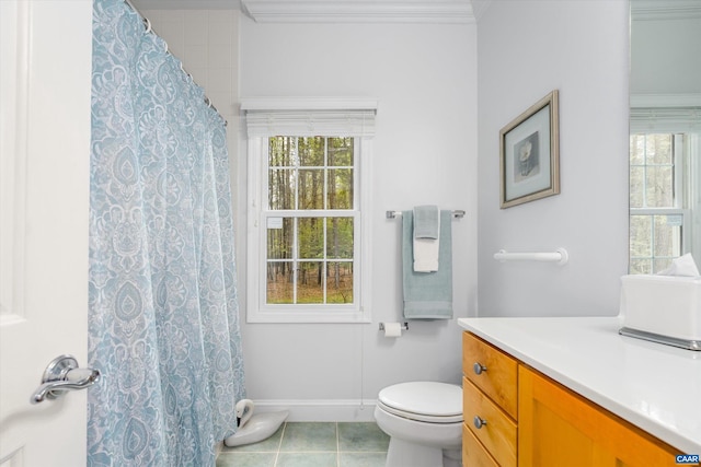 full bathroom featuring toilet, a healthy amount of sunlight, tile patterned flooring, and vanity