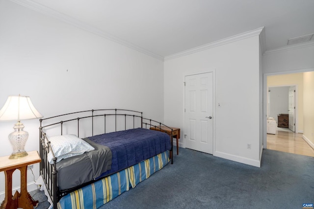 bedroom with crown molding, baseboards, and carpet floors