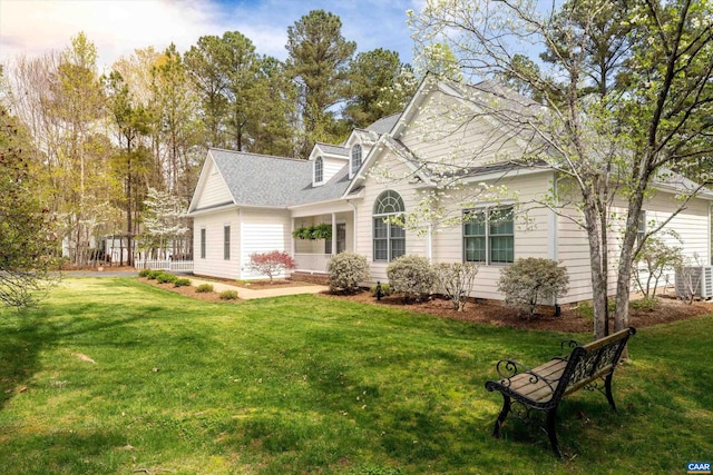 back of property featuring a lawn