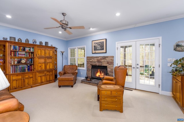 living room with ceiling fan, light colored carpet, french doors, baseboards, and ornamental molding