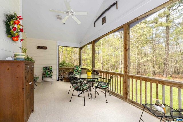 sunroom featuring a ceiling fan and outdoor dining space