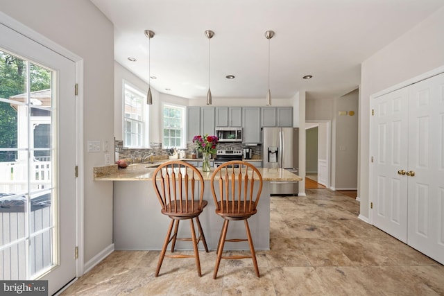 168 Sequester Dr, Stafford, VA 22556 - kitchen with appliances with stainless steel finishes, gray cabinetry, healthy amount of natural light, and a peninsula