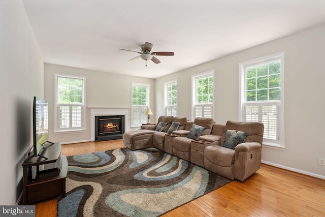 168 Sequester Dr, Stafford, VA 22556 - living area featuring healthy amount of natural light, ceiling fan, wood finished floors, and a fireplace with flush hearth
