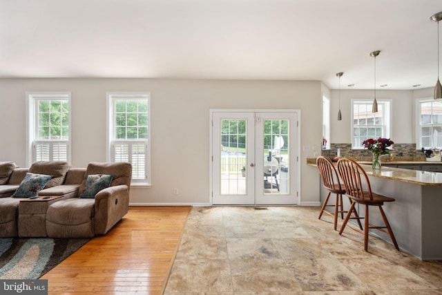 168 Sequester Dr, Stafford, VA 22556 - living room featuring healthy amount of natural light, french doors, baseboards, and wood finished floors