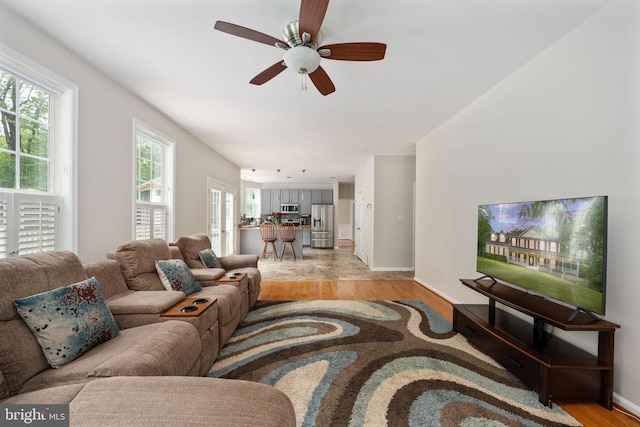 168 Sequester Dr, Stafford, VA 22556 - living area with light wood finished floors, a ceiling fan, and baseboards