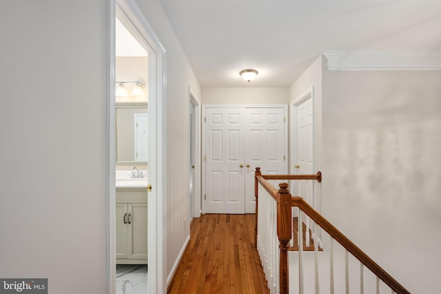168 Sequester Dr, Stafford, VA 22556 - hall with an upstairs landing, a sink, light wood finished floors, and baseboards