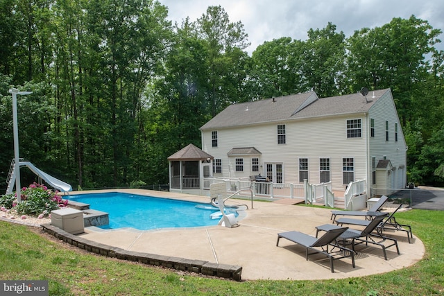 168 Sequester Dr, Stafford, VA 22556 - swimming pool with a water slide, a patio, a gazebo, and view of scattered trees