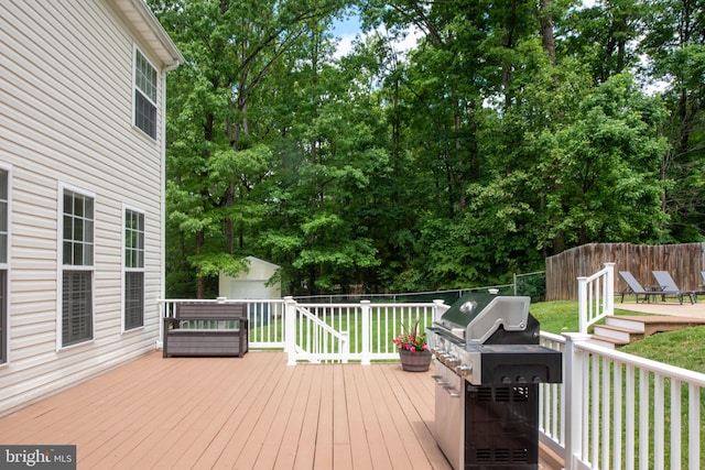 168 Sequester Dr, Stafford, VA 22556 - wooden terrace with a grill, a storage unit, an outbuilding, and view of scattered trees