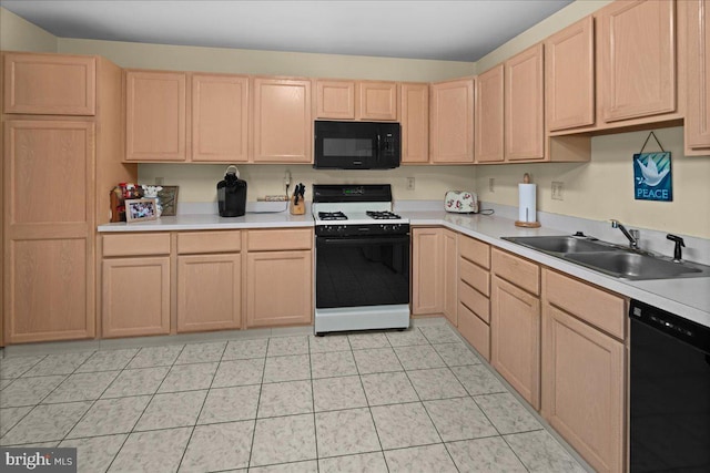 kitchen featuring a sink, black appliances, light brown cabinets, and light countertops
